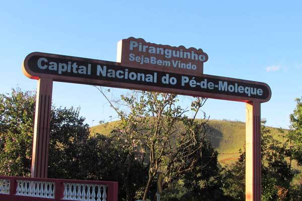 Portal do município de Piranguinho com uma placa de Capital Nacional do Pé de Moleque